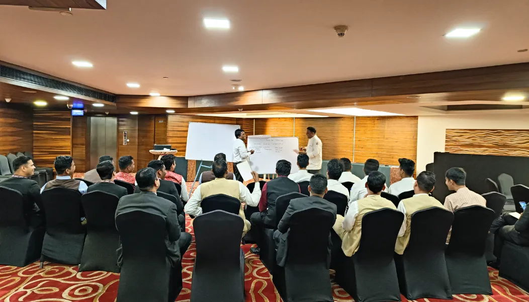 HTI trainer running a hospitality staff training session in a hotel banquet hall