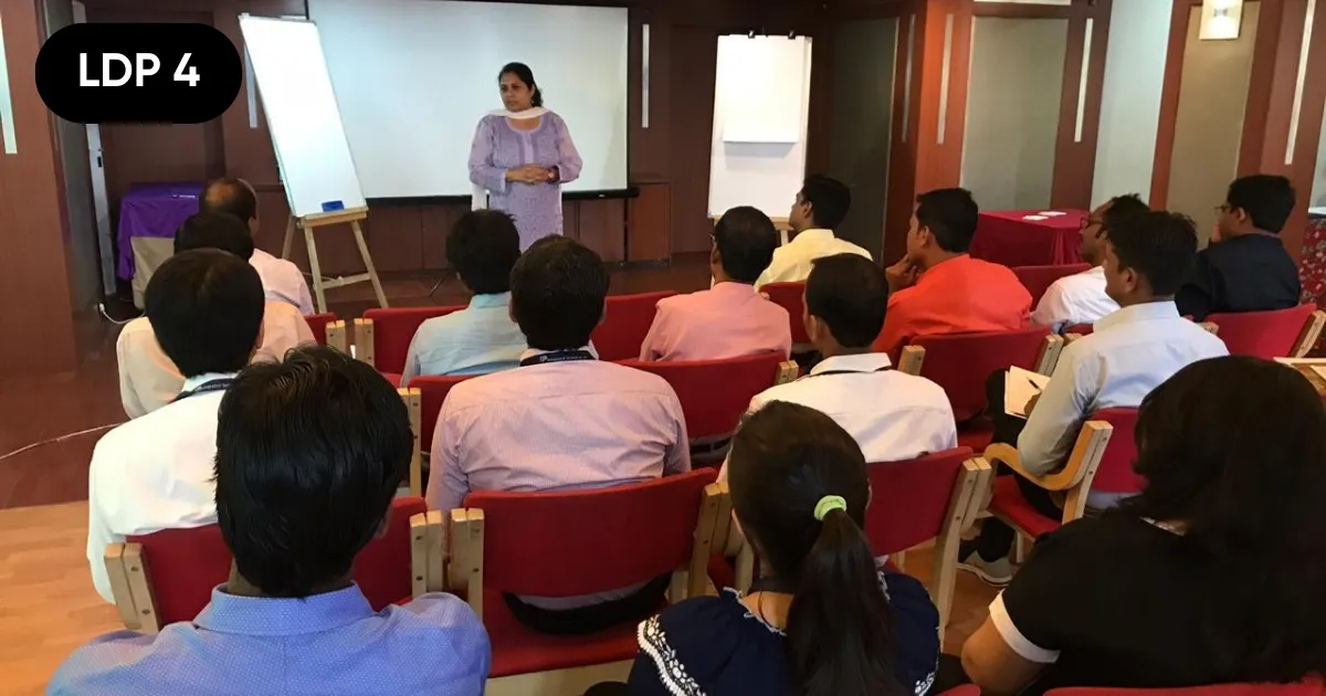 An HTI trainer leading the Art of War leadership session for a room of managers